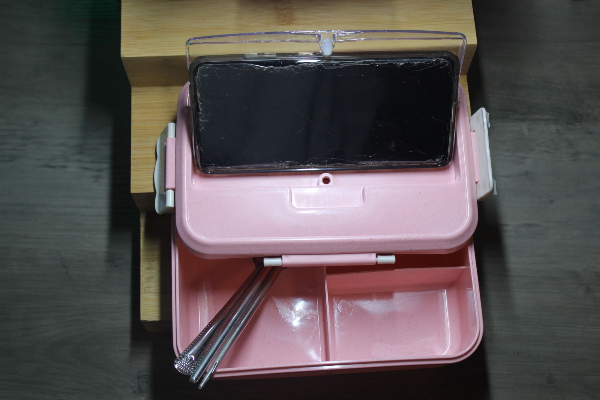 Pink bento box open with phone holder and utensil set
