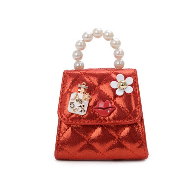 Red quilted mini crossbody bag with pearl top handle, flower charm, and key ring