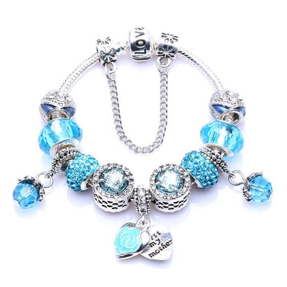 Silver charm bracelet with blue rhinestone beads and oval heart clasp charm
