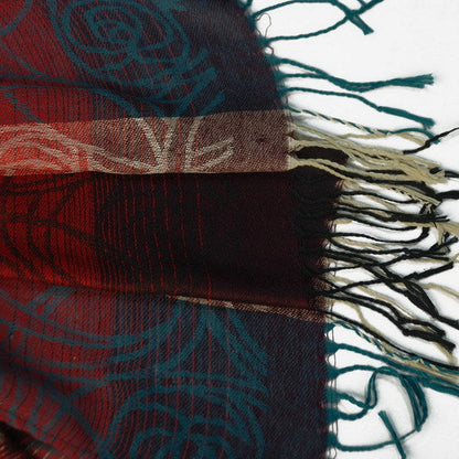 Pashmina shawl edge detail with multicolor woven pattern and dark tassels