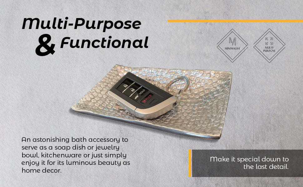 Rectangular hammered metal tray with a small dark accessory placed in the center