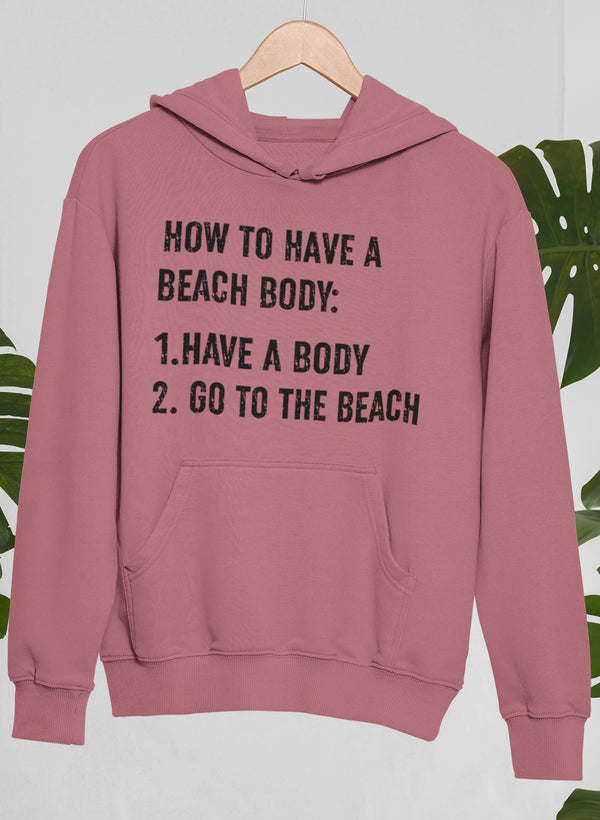 Mauve graphic hoodie with front pocket; "HOW TO HAVE A BEACH BODY" text