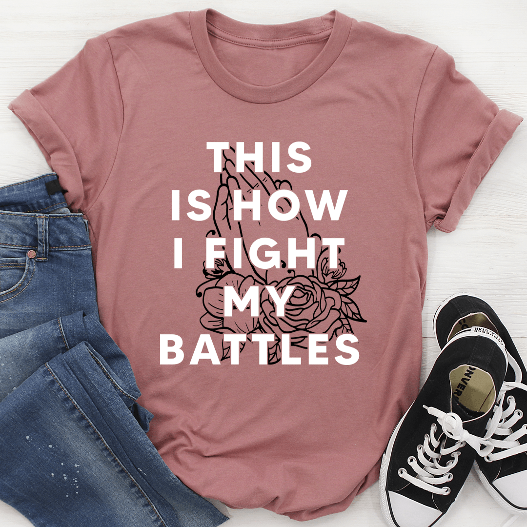 Mauve crew-neck graphic T-shirt with bold white text and rose artwork, short sleeves.
