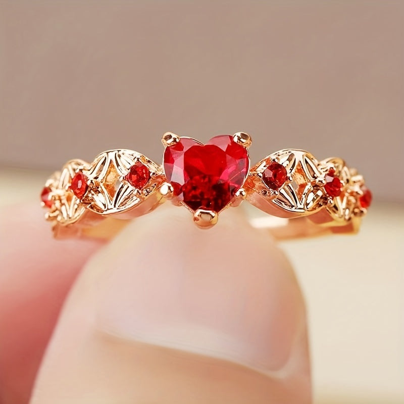 Rose gold heart zircon promise ring with large red center stone worn on finger