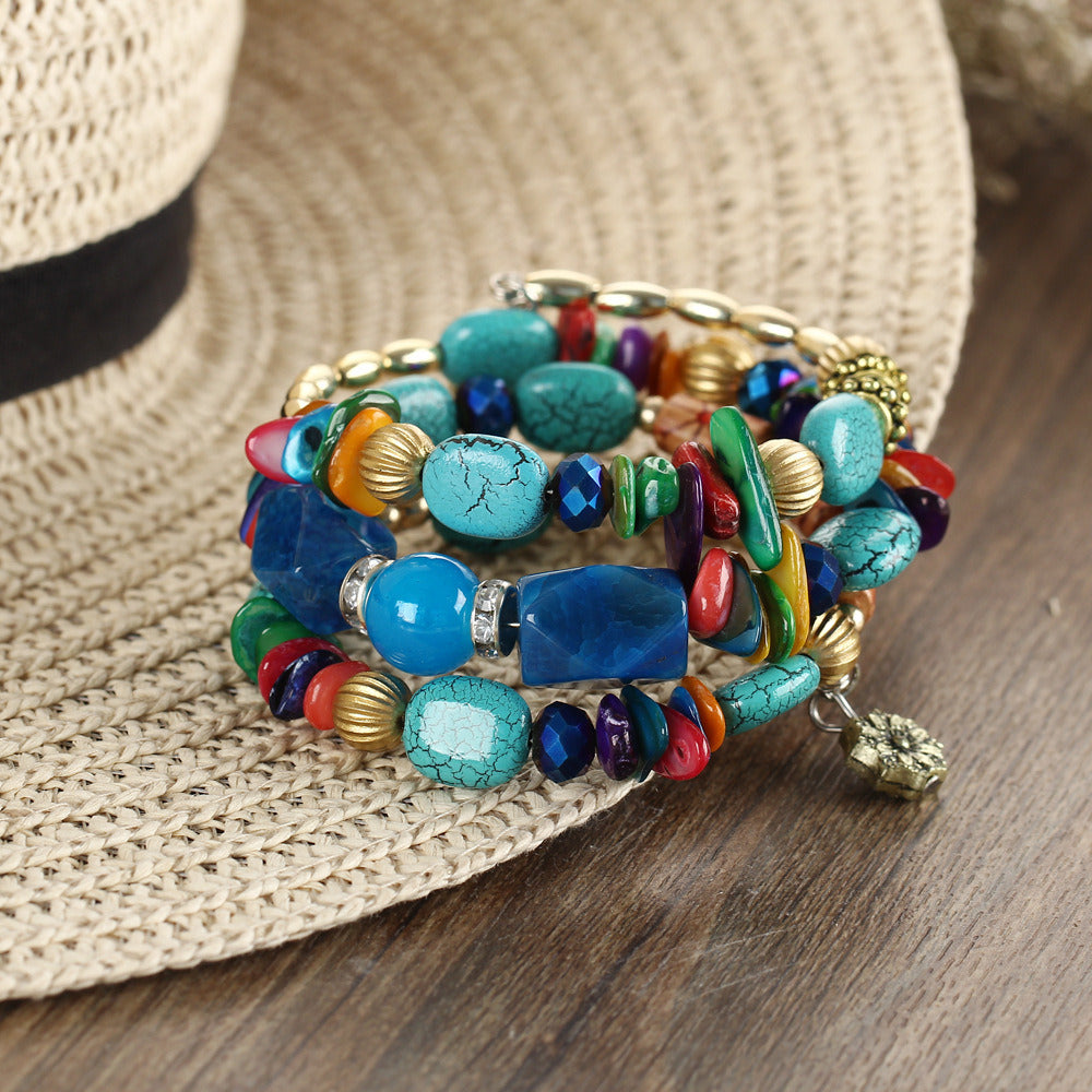 Multilayer boho charm bracelet with blue, turquoise, green, red beads and gold accents