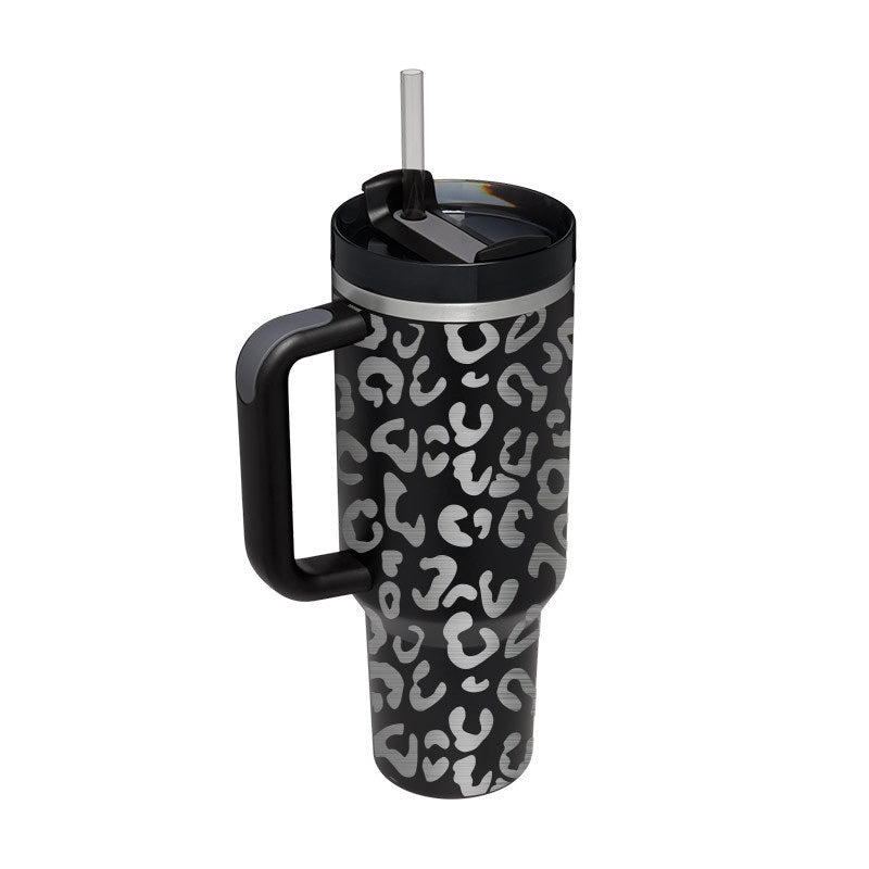 Vacuum insulated travel tumbler with leopard print in black and gray, featuring handle and straw lid.