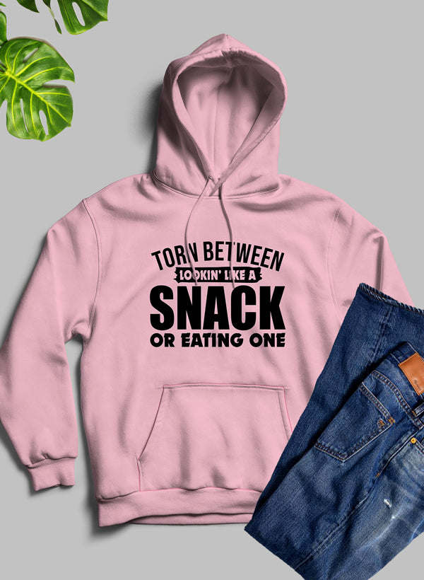 Pink hoodie with front kangaroo pocket and bold 'SNACK' graphic, hood up