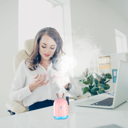 Pink cool mist humidifier on a desk, releasing visible mist
