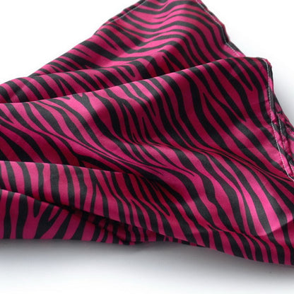Zebra-print silk scarf close-up, fuchsia and dark pink wavy stripes