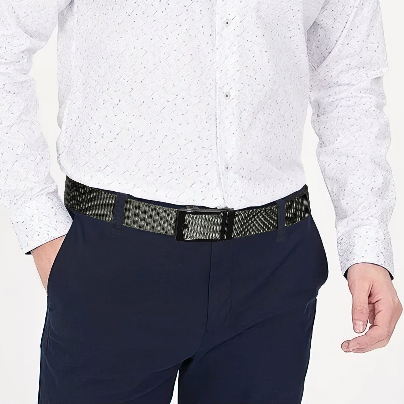 Olive nylon ratchet belt with black buckle on dark pants