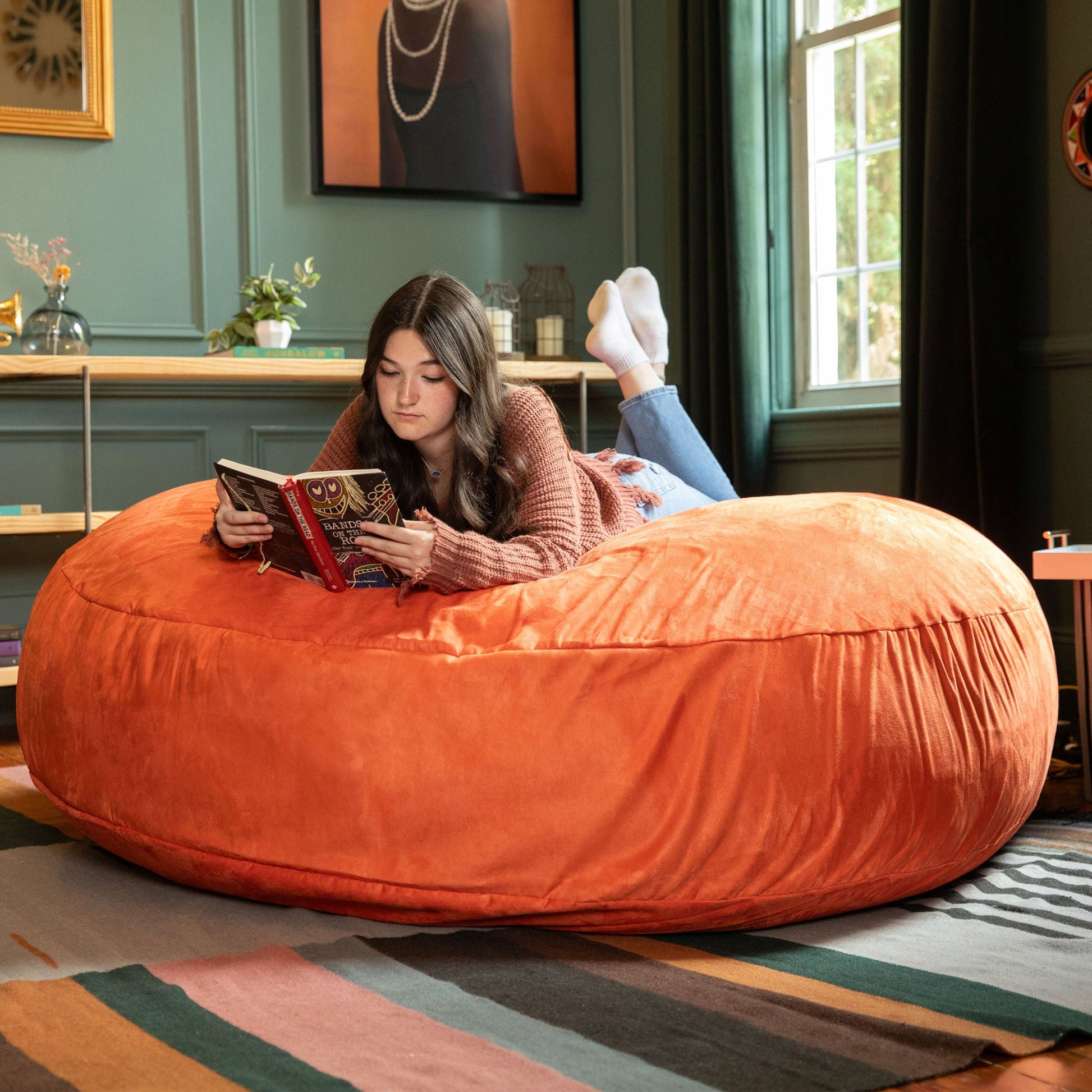 Mandarin orange cocoon bean bag chair with smooth plush cover and wide sitting area
