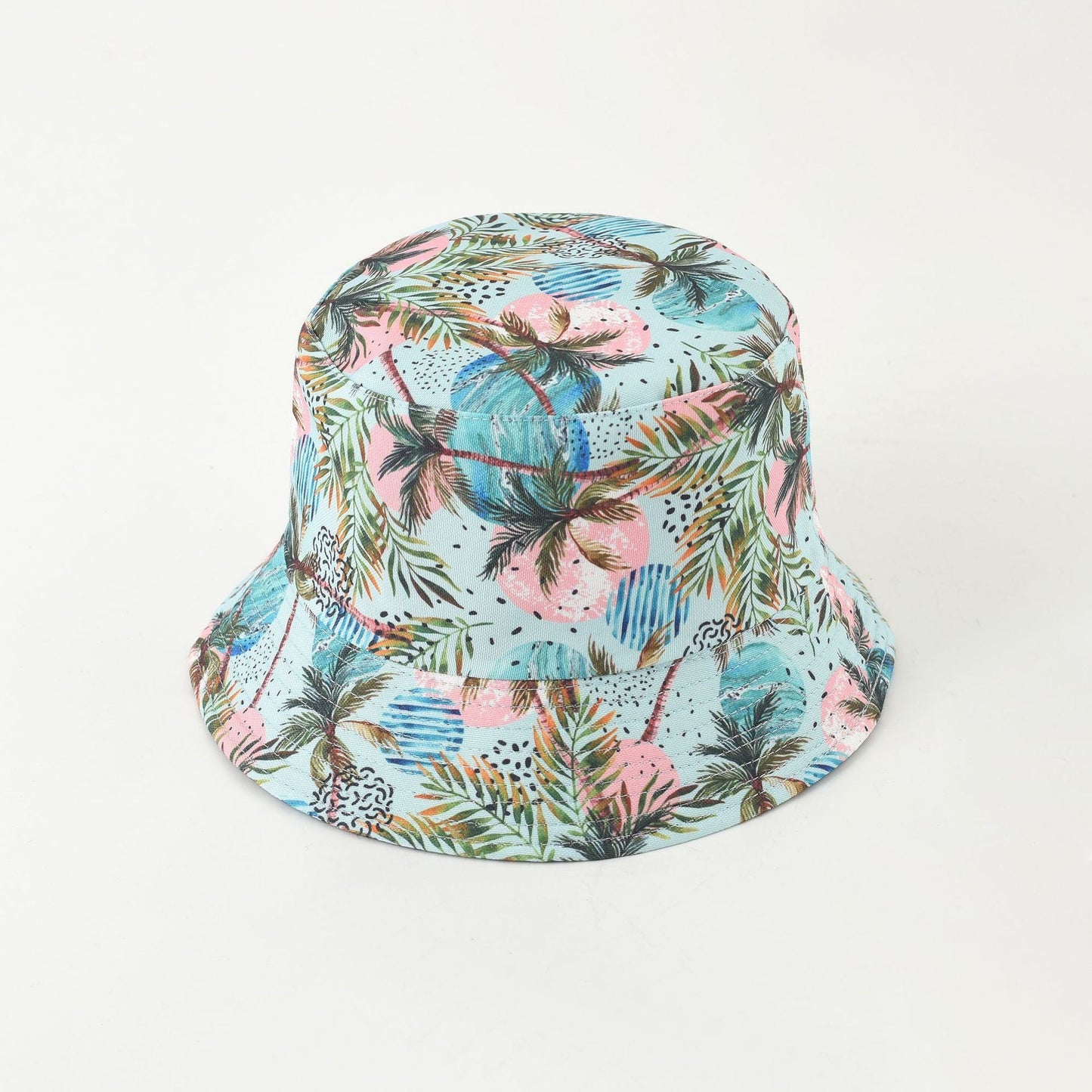 Light blue tropical bucket hat with colorful palm leaves and speckled accents