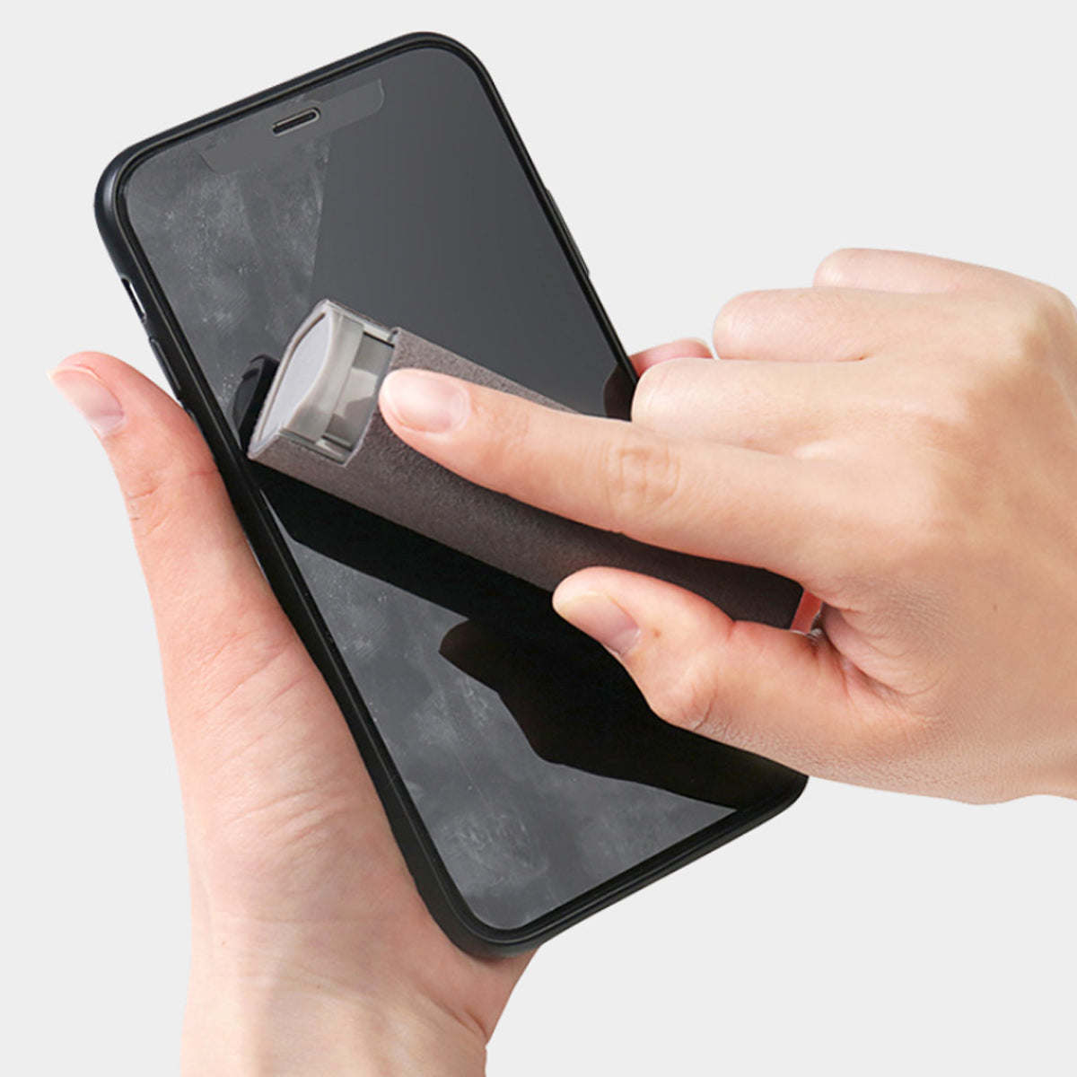 Smartphone screen being wiped with a cloth pad attached to a handle