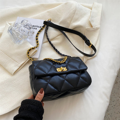 Black diamond-quilted mini shoulder bag with gold emblem and braided chain strap