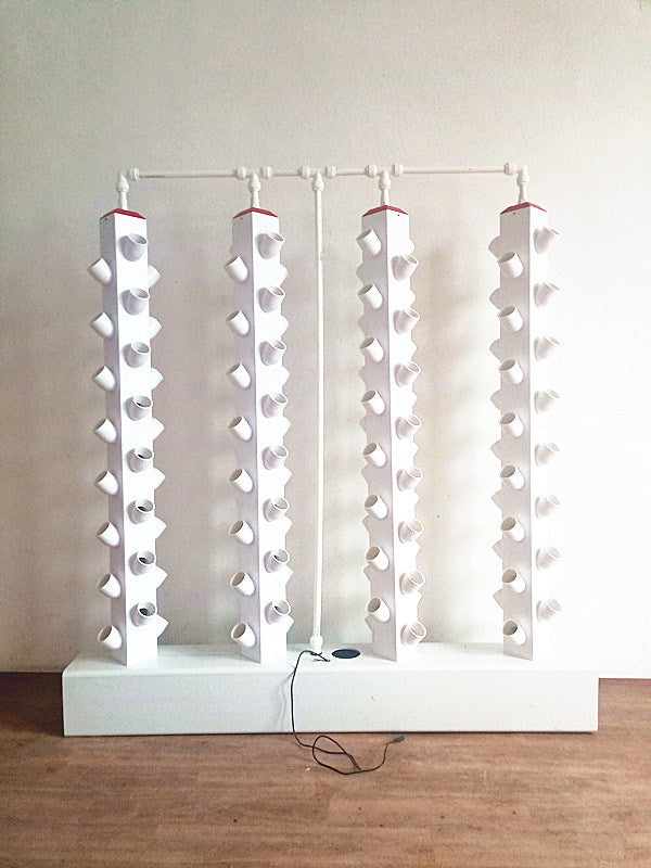 Set of white hydroponic vertical towers with multiple round grow sites