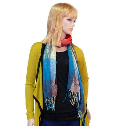 Tassel-trim pashmina shawl worn with blue, teal, and burgundy plaid