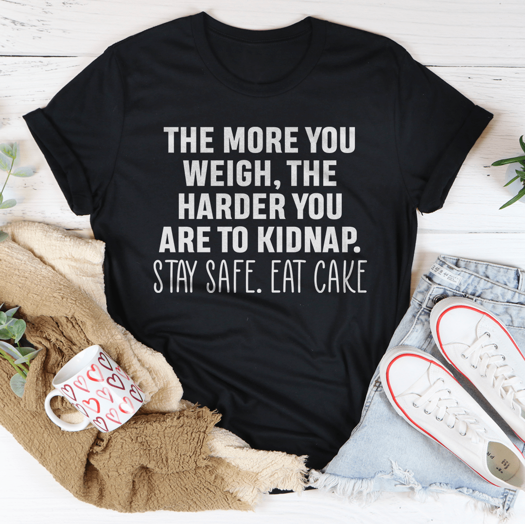 Black crewneck T-shirt laid flat, large quote print: THE MORE YOU WEIGH... EAT CAKE.