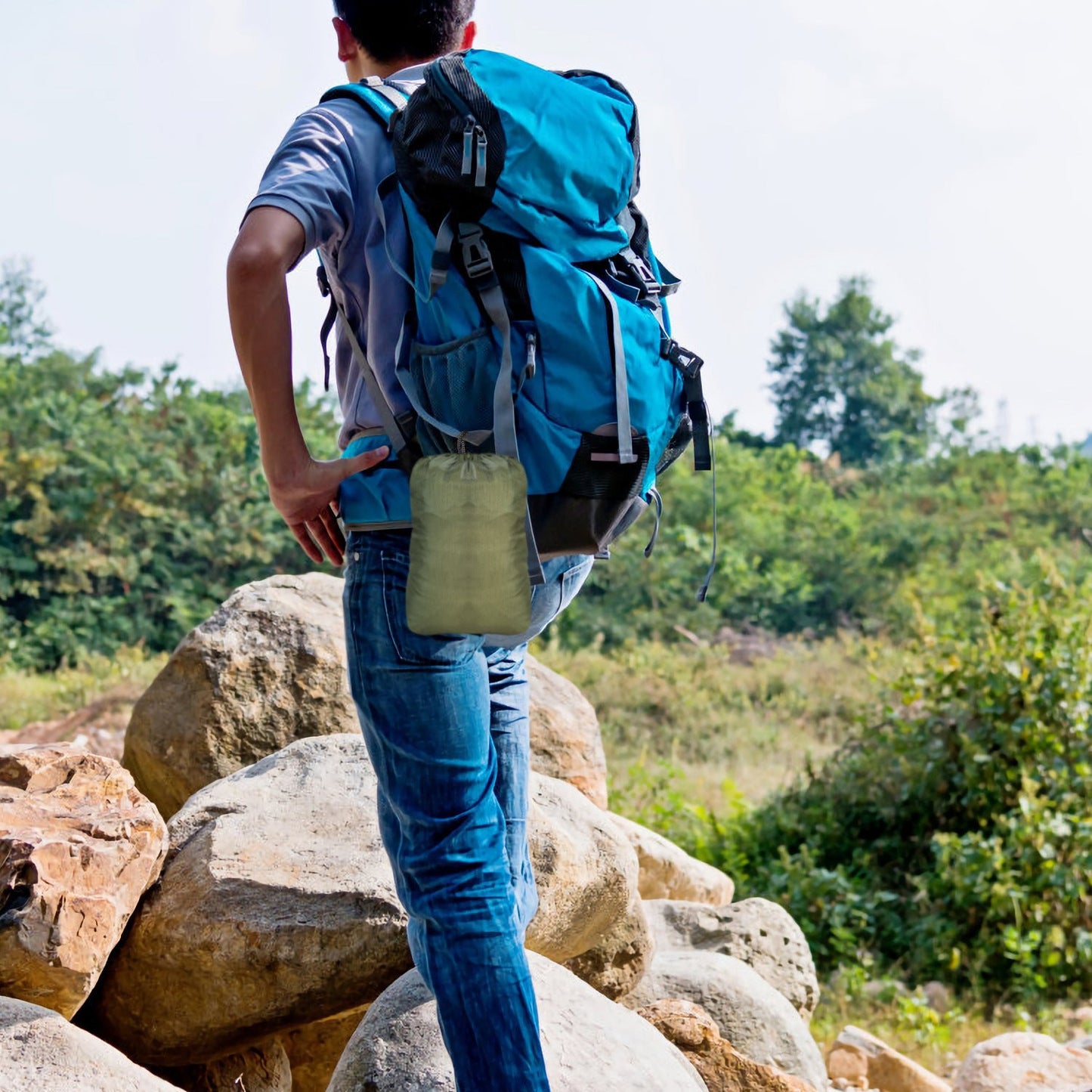 Camping hammock roll in a pouch, carried by a hiker backpack