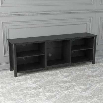 Black TV stand storage console with open compartments and drawers featuring round pulls.