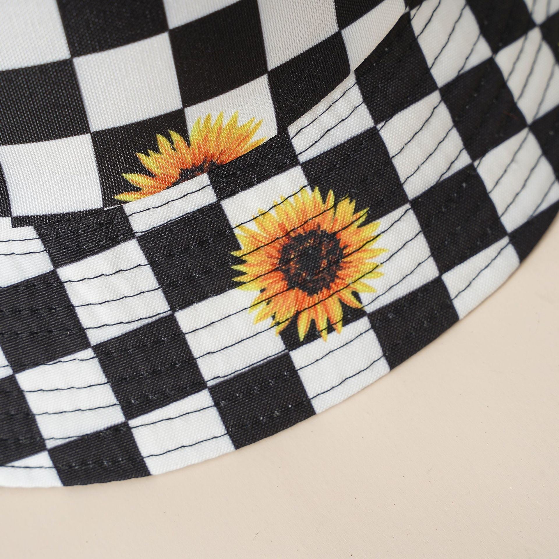 Checkerboard sunflower print bucket hat with dark brim trim