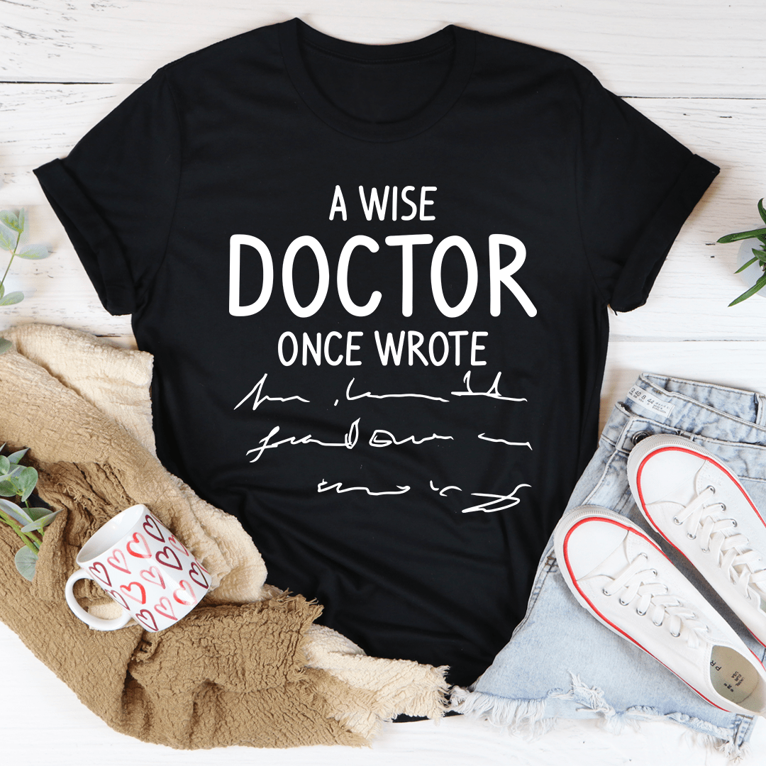 Black t-shirt with centered white “A WISE DOCTOR ONCE WROTE” graphic print.