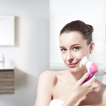 Pink-and-white electric face cleansing brush held near cheek