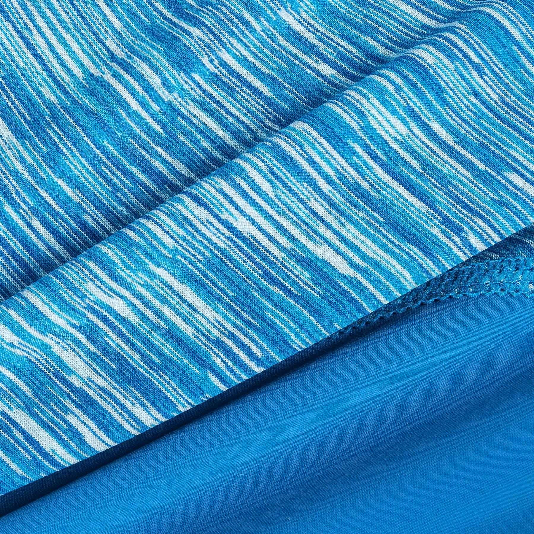 Close-up of blue heathered performance knit fabric with seam and textured trim