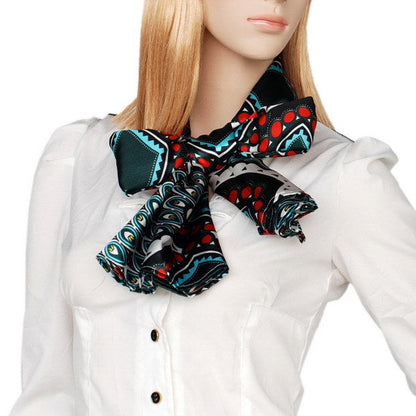 Dark green printed scarf with red and teal geometric motifs, styled at the neck