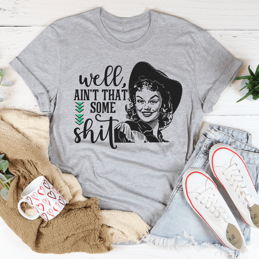 Heather gray graphic T-shirt with illustrated face and “Ain’t that some shit” lettering