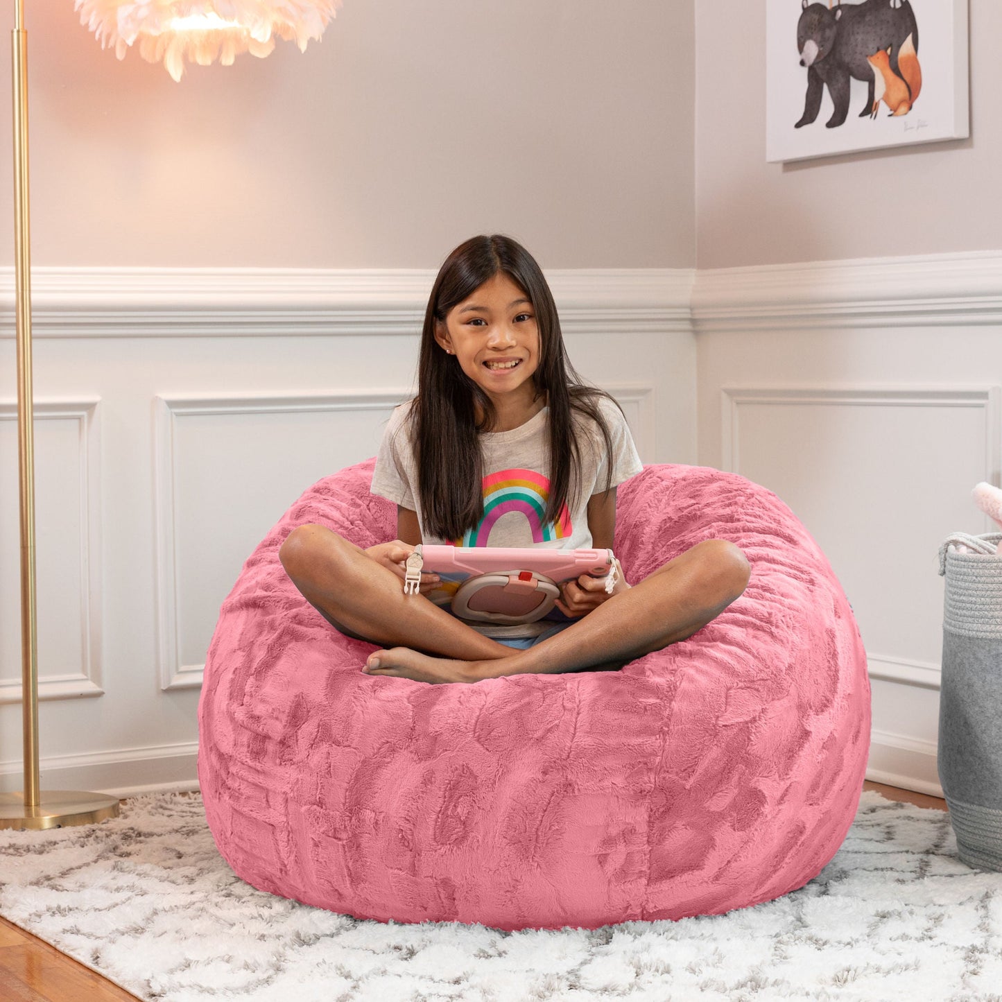 Rose Quartz faux fur bean bag chair with a child seated and arms resting inside.