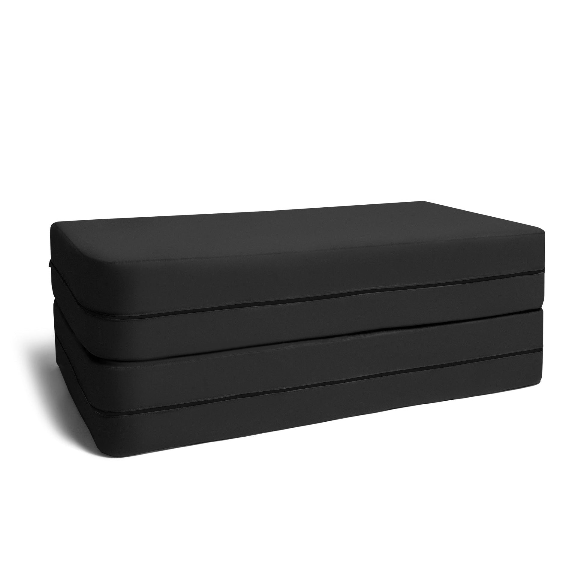 Black microsuede ottoman bench with layered cushioned sides and stitched panels