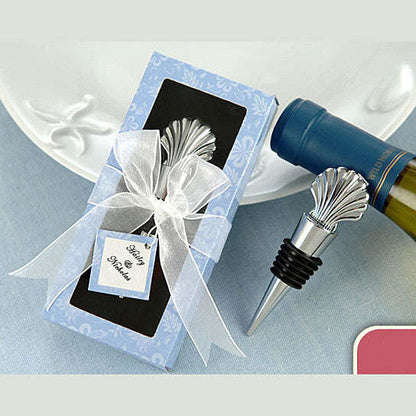 Seashell wine stopper with silver shell topper next to bottle and gift box