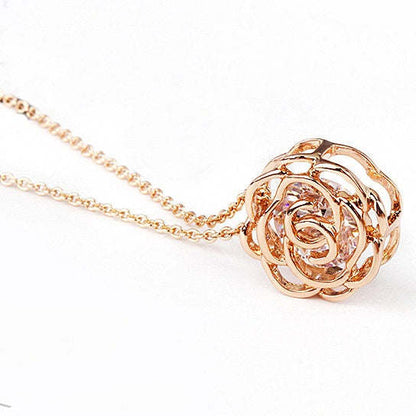 Rose pendant necklace with rose-motif filigree and small clear accent stone