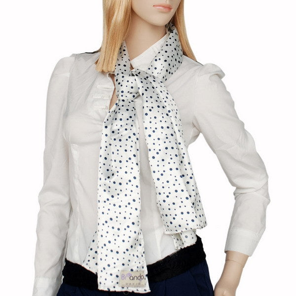 White silk scarf with small black dot pattern, tied at neck over light blouse