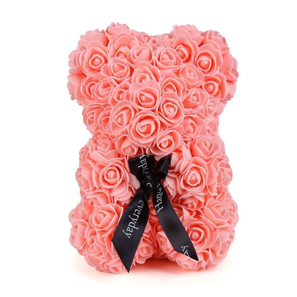 Pink rose teddy bear covered in rosette flowers, with black ribbon bow