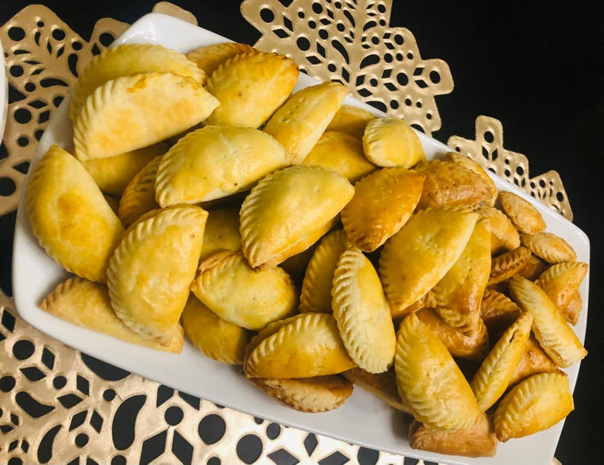 Plate of golden pastries with crimped edges