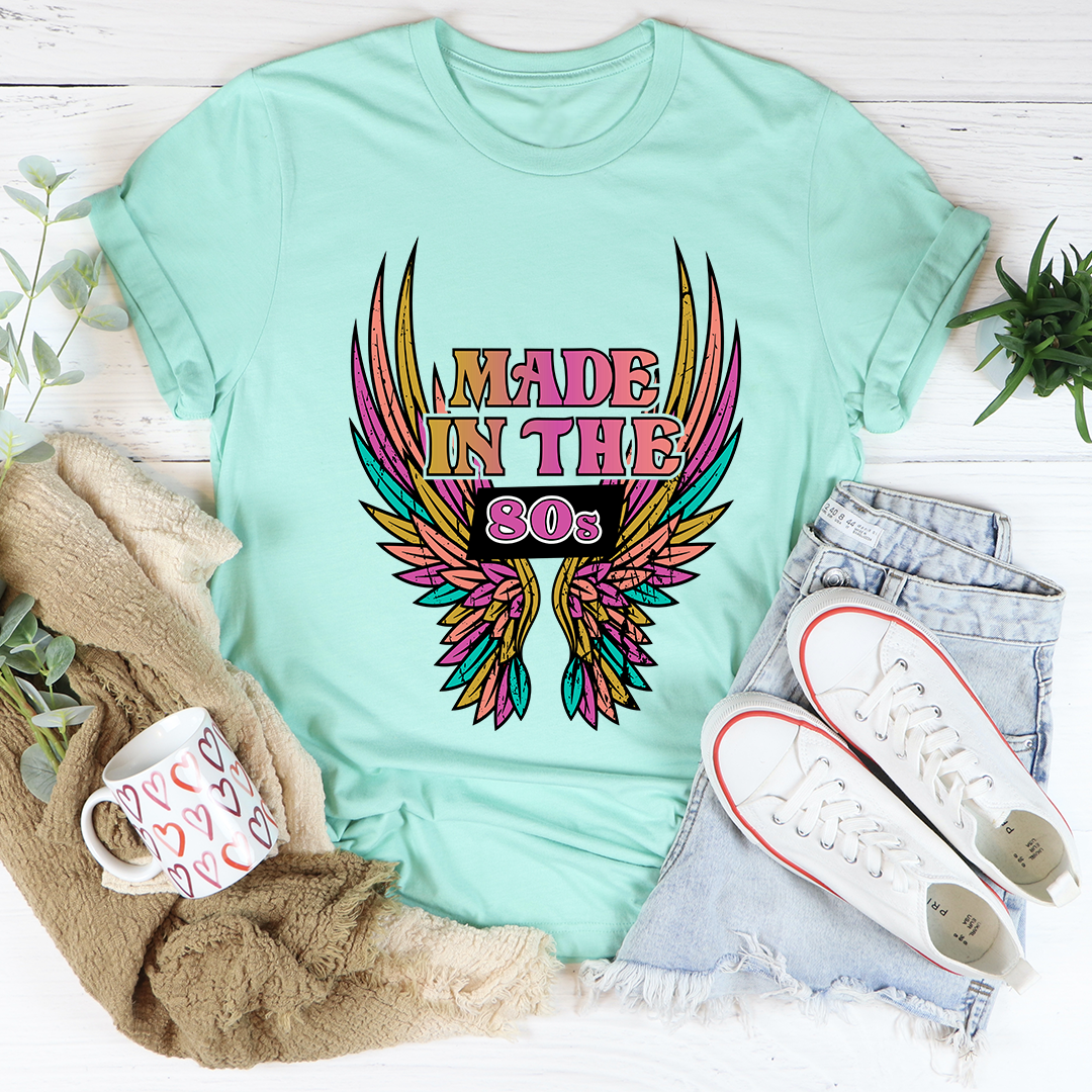 Mint green crew-neck graphic T-shirt with 'Made in the 80s' winged emblem