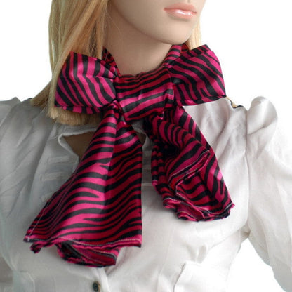 Zebra-print silk scarf worn with bow at front, fuchsia and dark pink stripes
