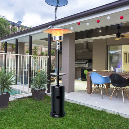 Black standing propane patio heater with tabletop and glowing burner for outdoor use