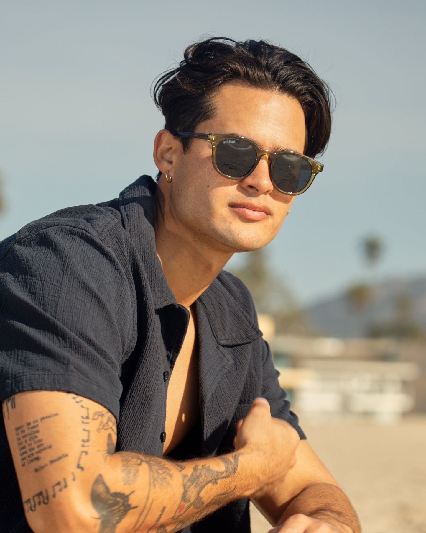 Olive green polarized sunglasses on a model, dark round lenses