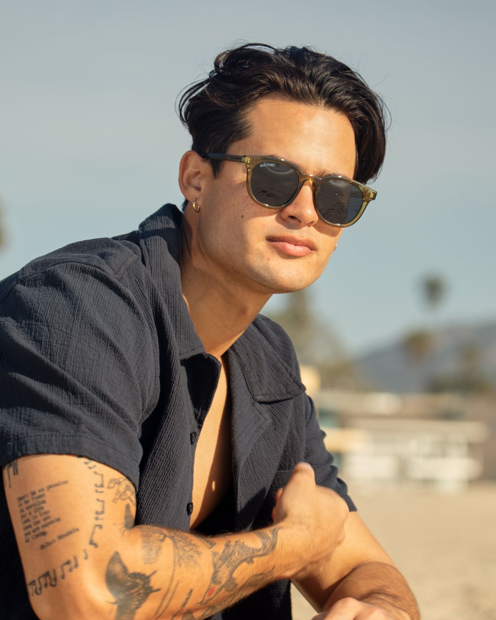 Olive green polarized sunglasses on a model, dark round lenses