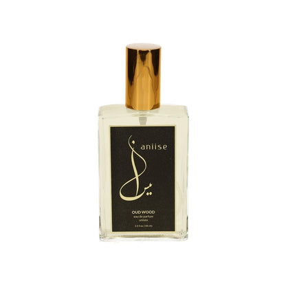 Eau de parfum spray bottle with clear glass, black label and gold cap