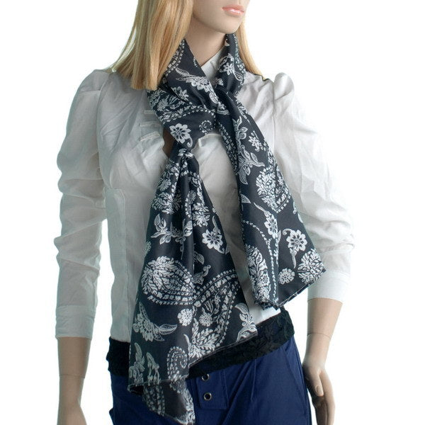 Silk scarf wrap with black base and white paisley floral print on model