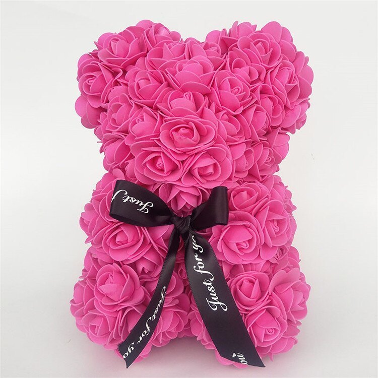 Bright pink rose teddy bear with layered rose petals and a black ribbon bow