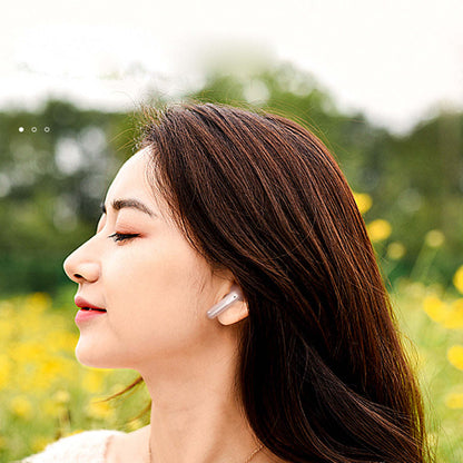 White wireless earbuds in a person’s ear