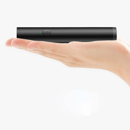 Black mini selfie stick held in hand, compact foldable body