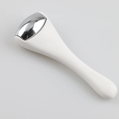 Ice roller massager on its side with white handle and silver roller head