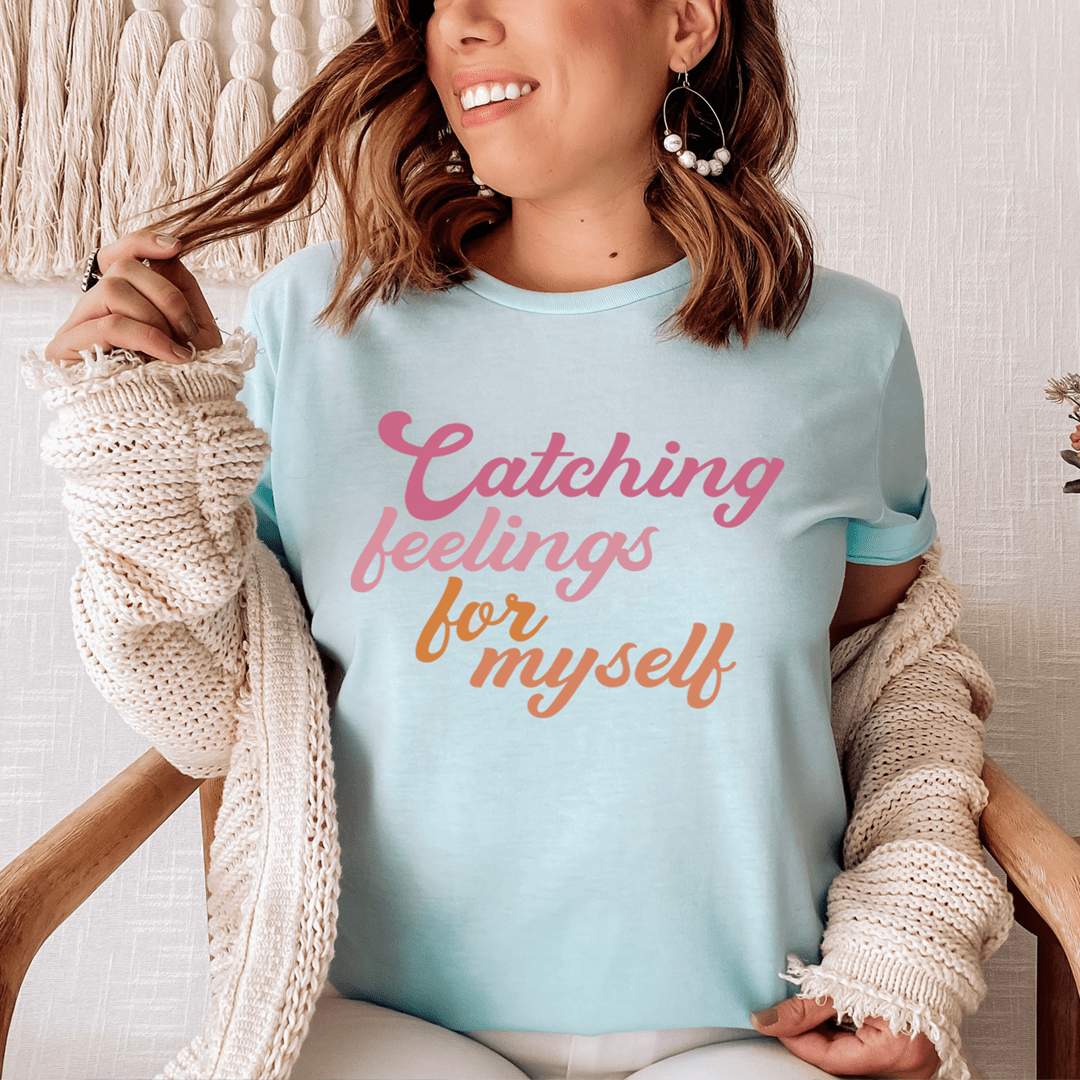 Ice blue crew-neck T-shirt with 'Catching feelings for myself' graphic