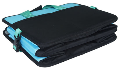 Folded travel pet bed, black cover with light blue base and teal-green strap tabs