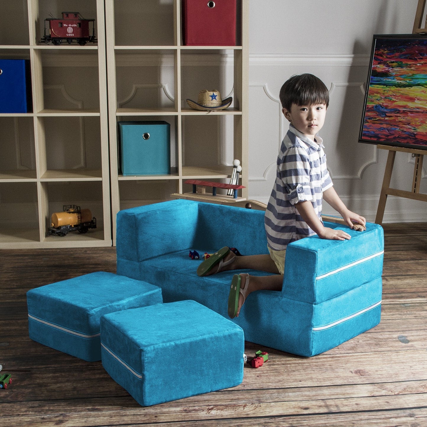Teal microsuede modular kids loveseat with two ottomans and built-in play area on top.